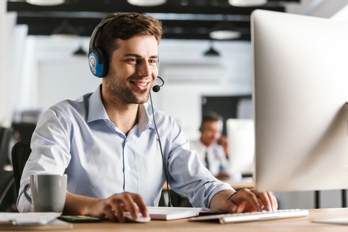 photo-young-worker-man-20s-wearing-office-clothes-headset-smiling-talking-with-clients-call-center-1