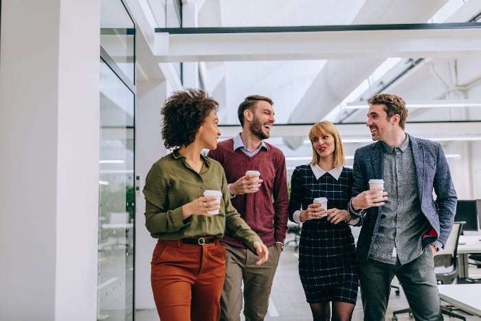 a group of coworkers walking with coffee