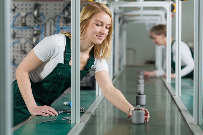 a woman working on a manufacturing line