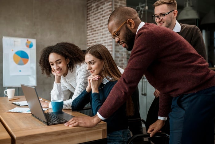 woman-showing-something-her-colleagues-during-meeting-1